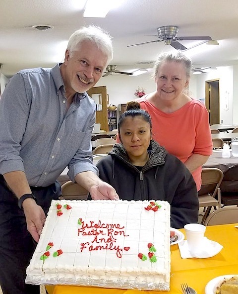 Pastor and two women with cake