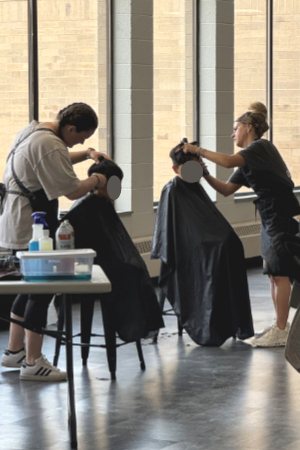 two people giving haircuts